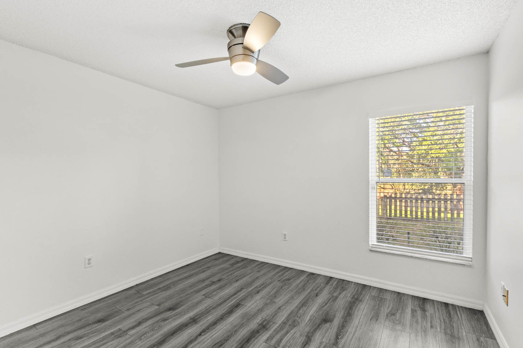 bedroom with grey wooden floors